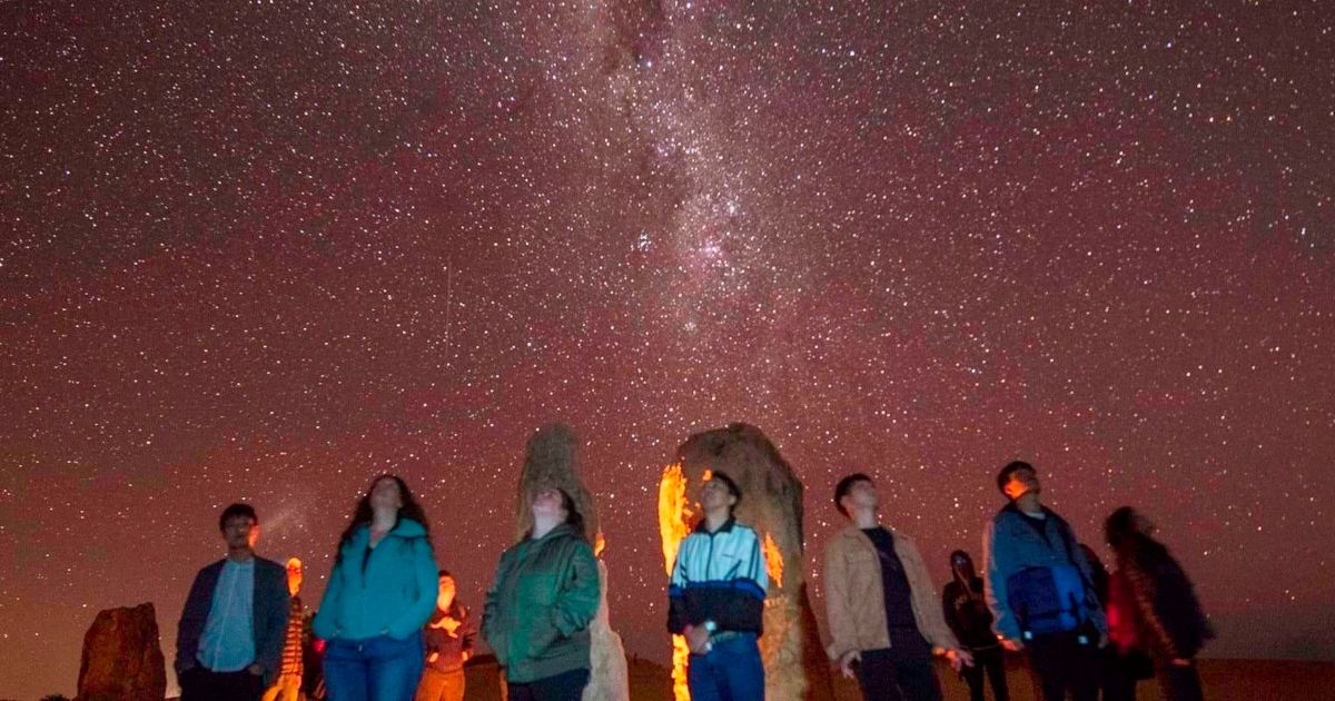 Group of travellers enjoying the night sky at Pinnacles Dessert